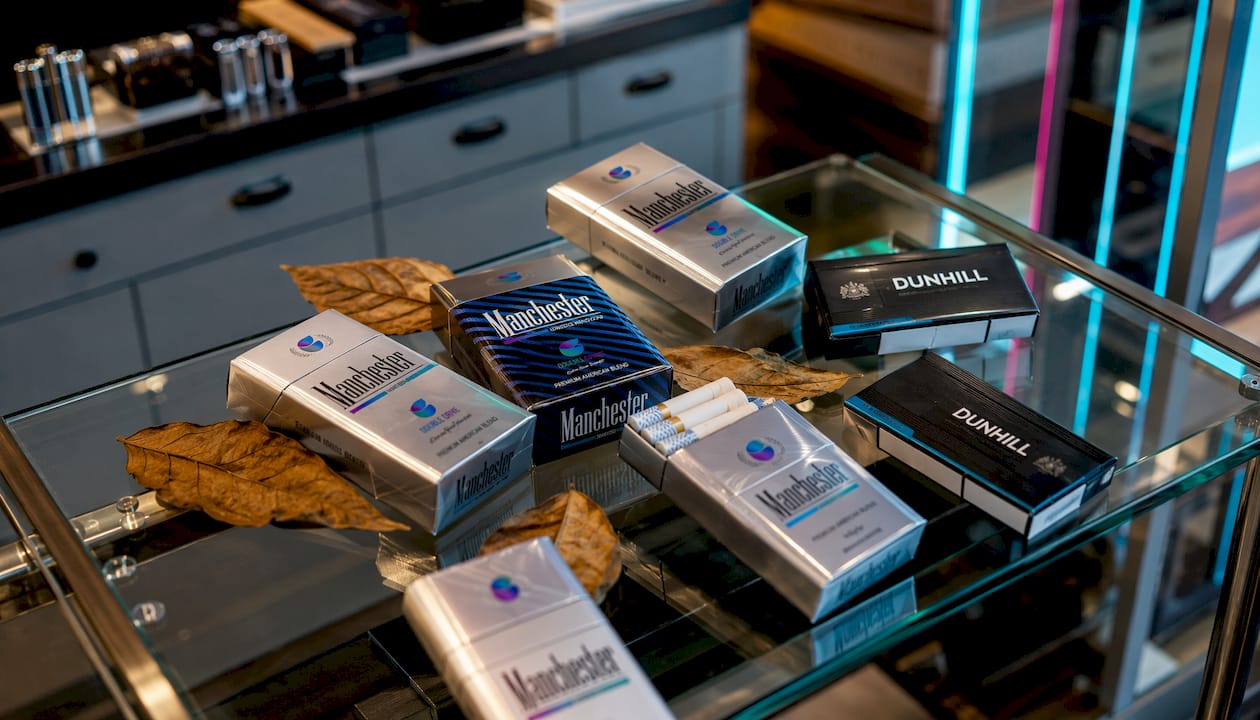Premium cigarette cartons on wooden retail display