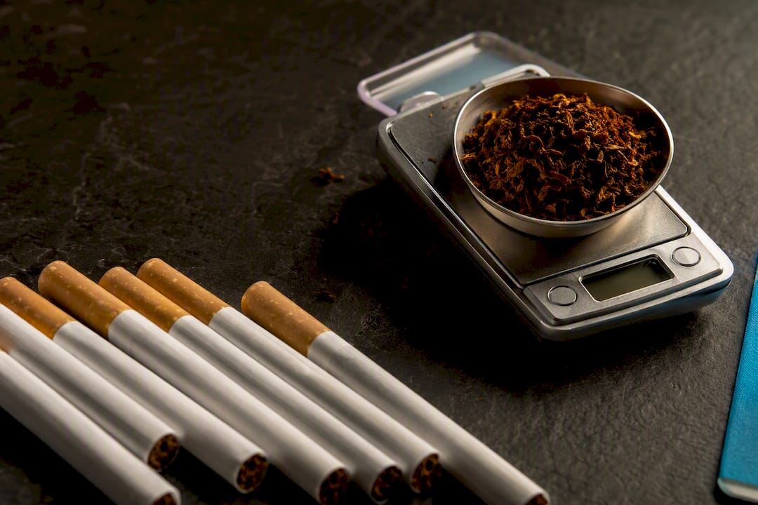 Anonymous tobacco products beside precision weighing scale